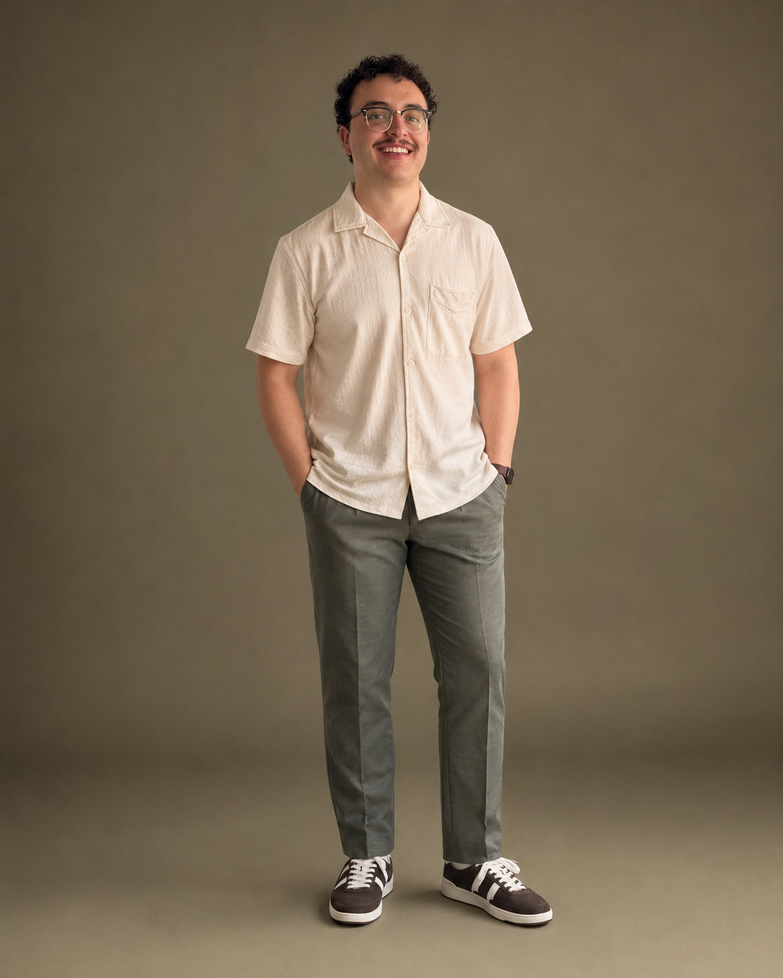 Matthew Dunston smiling in a cream shirt against a warm neutral background